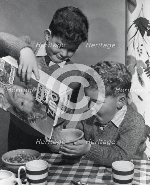 Two boys having a bowl of Quiz Corn Flakes, c1955.  Creator: Arthur Charles Kirby Ware.