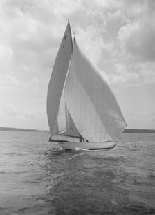 The 7 Metre 'Marsinah' (K1) sailing with spinnaker, 1912. Creator: Kirk & Sons of Cowes.