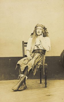 A man in drag sits pensively on a chair, on the deck of a ship, (between 1910 and 1919?). Creator: Unknown.