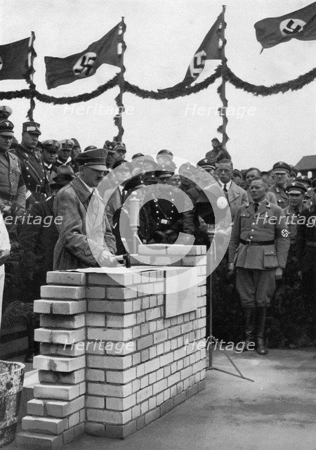 The Führer puts the foundation wall to the meeting house in the Adolf-Hitler-Koog. Artist: Unknown