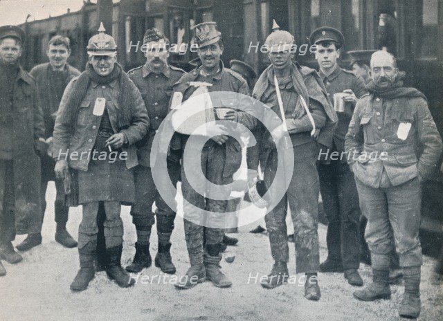 Some cheerful wounded from the Neuve Chapelle fighting, wearing captured German helmets, 1915. Artist: Unknown