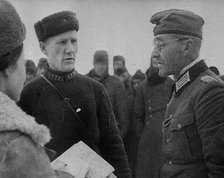 Two Russian Soldiers Talking to a German Prisoner of War, 1941. Creator: British Pathe Ltd.