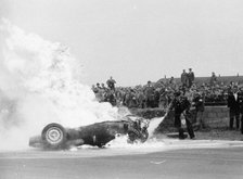 Tony Brooks' car on fire at the British Grand Prix, Silverstone, Northamptonshire,1956. Artist: Unknown