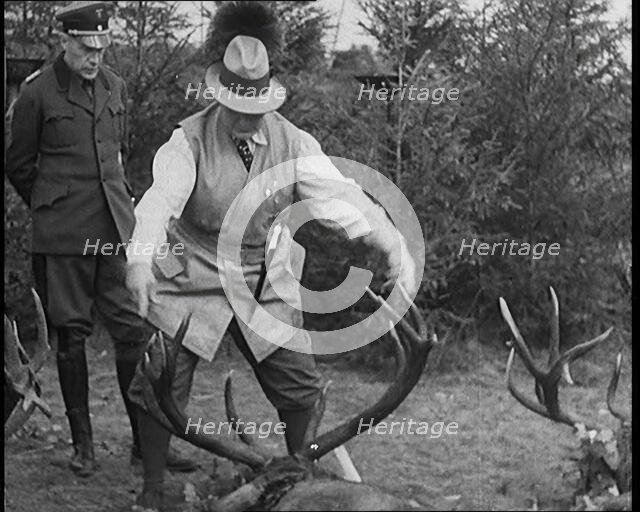 Nazi Officer Hermann Goering in Hunting Dress Showing His Colleagues a Line of Deer He..., 1931. Creator: British Pathe Ltd.