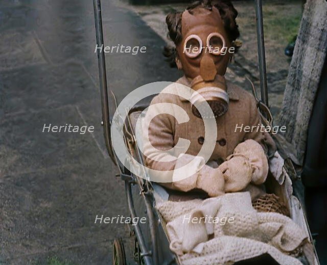 A Young Child in a Pram Wearing a Gas Mask, 1939. Creator: British Pathe Ltd.