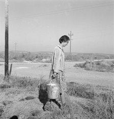 Mrs. Bartheloma hauls water from irrigation ditch, Nyssa Heights, Malheur County, Oregon, 1939. Creator: Dorothea Lange.