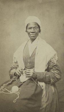 Portrait of abolitionist Sojourner Truth, sitting with yarn and knitting needles, 1864. Creator: JH Preiter.
