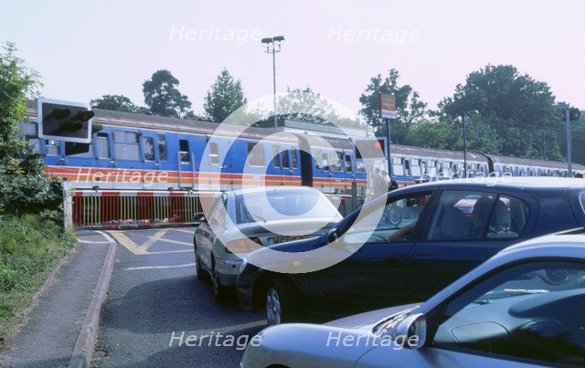 Traffic queue at level crossing in Brockenhurst, Hampshire. Artist: Unknown.