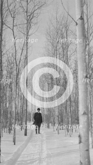 Rev. Burgess on snow covered road, between c1900 and 1927. Creator: Unknown.