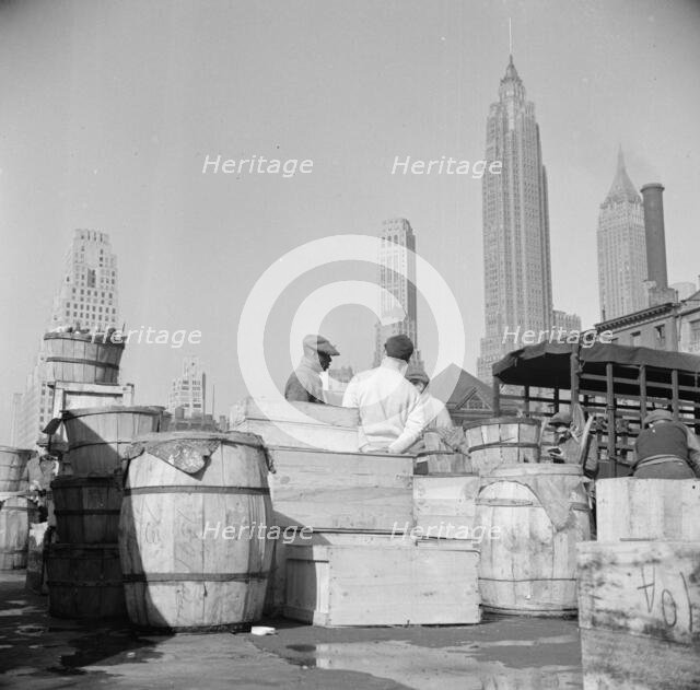 Fish caught off the New England coast is packed in these barrels and boxes and..., New York, 1943. Creator: Gordon Parks.