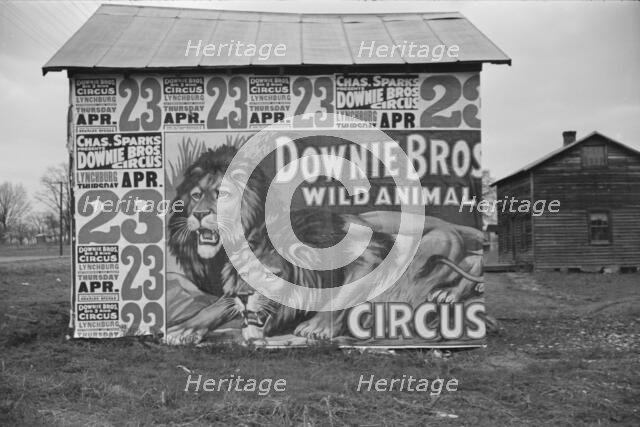 Posters covering a building near Lynchburg to advertise a Downie Bros. circus, 1936. Creator: Walker Evans.