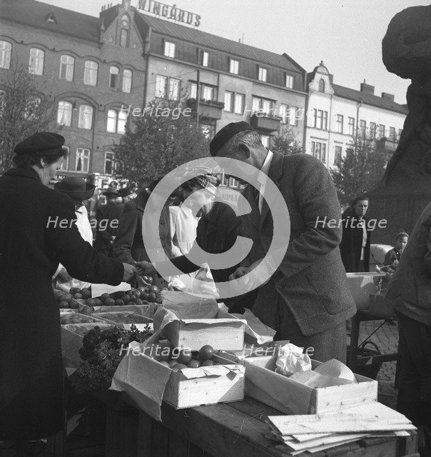 Fruit and vegetable stall in the market, Malmö, Sweden, 1947. Artist: Otto Ohm