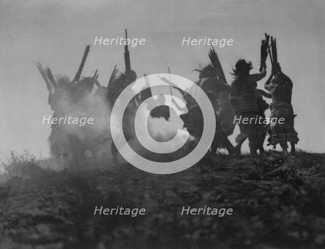 Dancing to restore an eclipsed moon, c1914. Creator: Edward Sheriff Curtis.