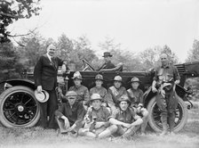 Group of Boy Scouts Posed with Dog And Three Men in Front of An Automobile, between 1914 and 1917. Creator: Harris & Ewing.