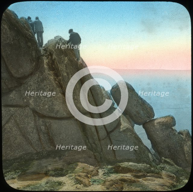 Climbing the Logan Rock, near Treen, Cornwall, late 19th or early 20th century.  Artist: Church Army Lantern Department