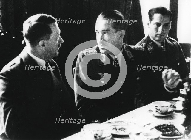 Adolf Hitler in conversation with German air force fighter ace Adolf Galland, 1941. Artist: Unknown