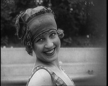 Young Female Civilian Wearing a Jaunty Swimming Hat Posing for the Camera, 1920. Creator: British Pathe Ltd.