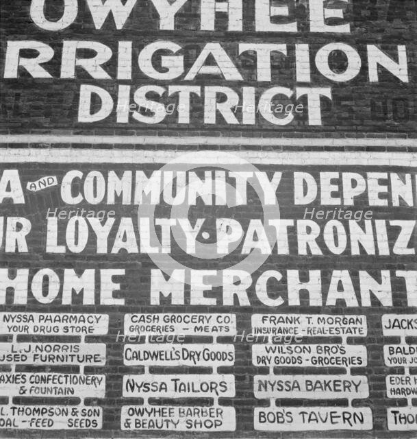 Sign on old bank building now used for office of Bureau..., Nyssa, Malheur County, Oregon, 1939. Creator: Dorothea Lange.