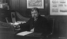 Man (banker?) seated at desk in American Security and Trust Co., Washington, D.C., c1890 - c1950. Creator: Frances Benjamin Johnston.