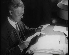 Journalist at Work Reading Notes, 1921. Creator: British Pathe Ltd.