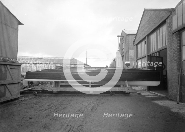 Cabin cruiser D.G.S.I. on stand at boatyard, 1913. Creator: Kirk & Sons of Cowes.