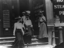 Women coming from work, Cal.?. Store window reads T.B. Reardon, heating and plumbing, 1903. Creator: Frances Benjamin Johnston.