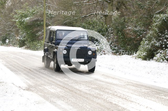 2002 Land Rover Defender driving on snowy road, 2009 Artist: Unknown.