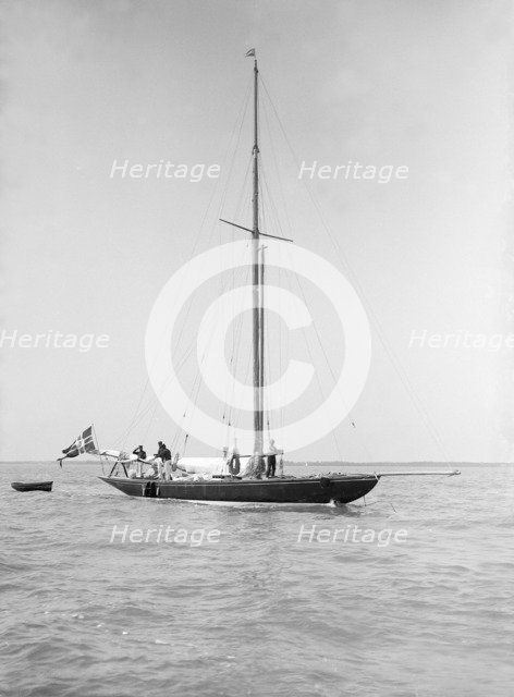 The sailing yacht 'Rollo' at anchor, 1911. Creator: Kirk & Sons of Cowes.