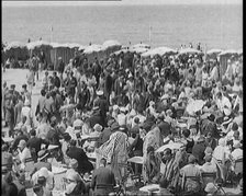 Civilians Enjoying a Sunny day on a Very Crowded Beach, 1920. Creator: British Pathe Ltd.