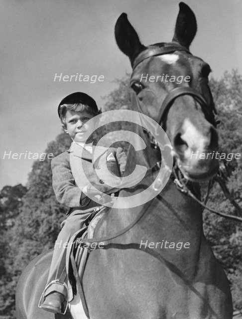 Crown Prince Carl Gustaf of Sweden and his horse, Nivea, Haga Castle, Sweden 1952. Artist: Unknown