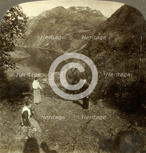 'Haying on mountain shelf high above Marok village and mirror-clear Geirangerfjord, Norway', c1905 Creator: Unknown.