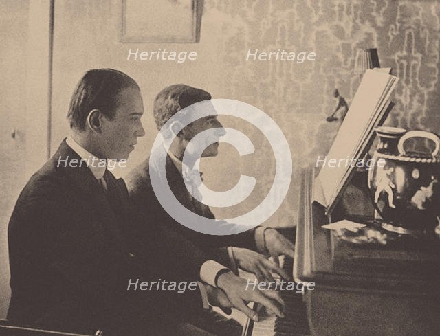 Nijinsky and Maurice Ravel at the piano playing a score from Daphnis and Chloe, 1912. Artist: Anonymous  