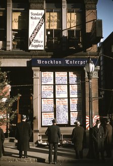 Men reading headlines posted in street-corner of Brockton Enterprise...office, Brockton, Mass., 1940 Creator: Jack Delano.
