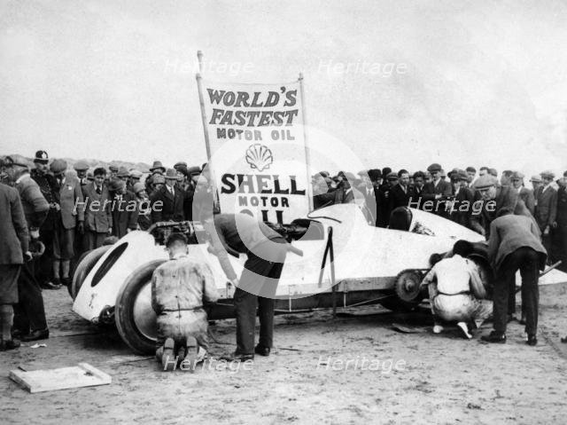 BABS with Parry Thomas, having wheel changed at Pendine sands 1926. Creator: Unknown.