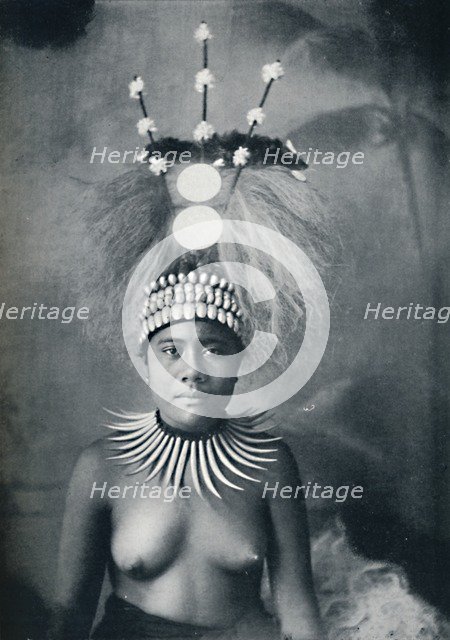 A Samoan woman wearing a collar of cachalots' teeth and a ceremonial headdress, 1902. Artist: Josiah Martin.