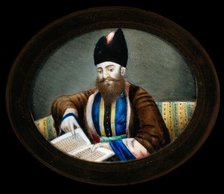 An Indian (?) man seated, reading a book. Creator: Unknown.