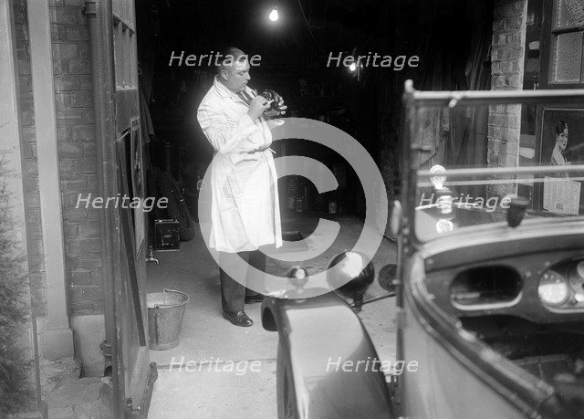 FA Thatcher working on his 1929 Triumph Super Seven. Artist: Bill Brunell.