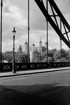 The Tower of London, viewed here through the cable supports of Tower Bridge, c1945-c1965. Artist: SW Rawlings