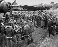 A Large Group of American Pilots Standing Below a Bomber Aircraft. Several Pilots are..., 1943-1944. Creator: British Pathe Ltd.