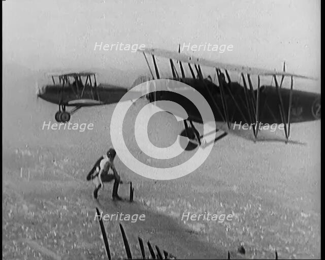 A Wing Walking Female Civilian Changes the Wheel of an Aeroplane in Flight, 1926. Creator: British Pathe Ltd.