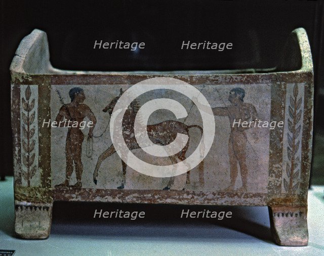 Etruscan funerary urn decorated with two men and a horse, preserved in the National Etruscan Muse…