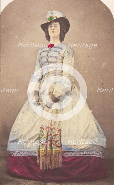 A man in drag wearing an elaborate dress and feathered hat, (20th century?). Creator: Unknown.