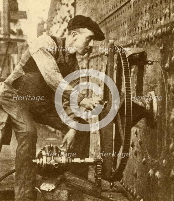 'A Pneumatic Riveter Cutting Portholes in the Side of a Liner', c1930. Creator: John Brown & Company.