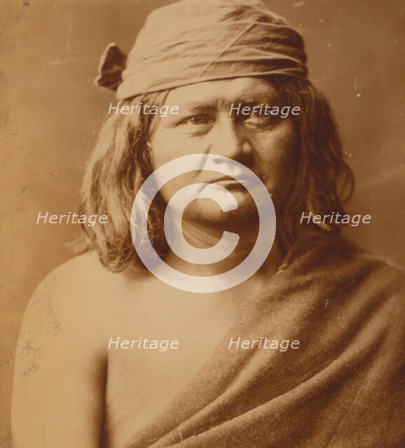 Native man, head-and-shoulders portrait, facing front, c1903. Creator: Edward Sheriff Curtis.