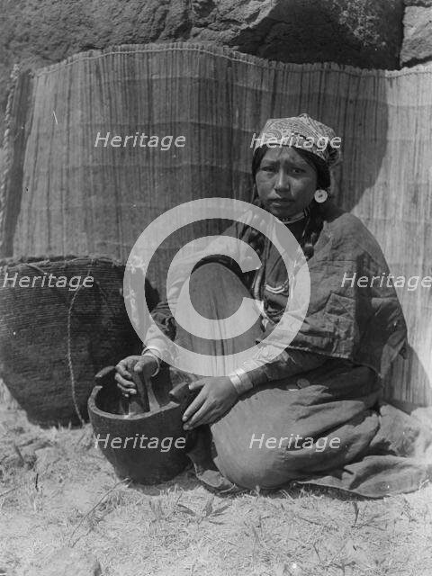 Pounding fish-Wishram, c1910. Creator: Edward Sheriff Curtis.