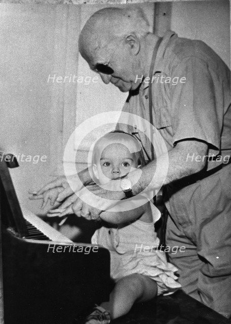 David Ben Gurion (1886-1973) trying to teach piano to his little granddaughter. Artist: Unknown