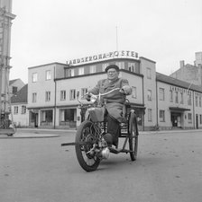A disabled man with his motorised wheelchair, Landskrona, Sweden, 1952. Artist: Unknown