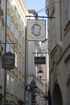 Detail view of the traditional signs along an old building on Getreidegasse, Salzburg, Austria, 2022 Creator: Ethel Davies.