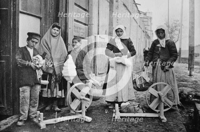 Erivan : Taking home spinning wheels & cotton, between c1915 and c1920. Creator: Bain News Service.
