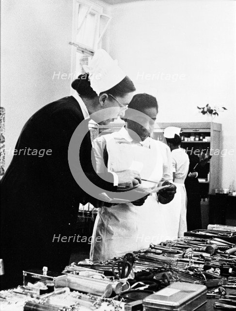 A nurse being trained, 1960. Creator: Henry Grant.